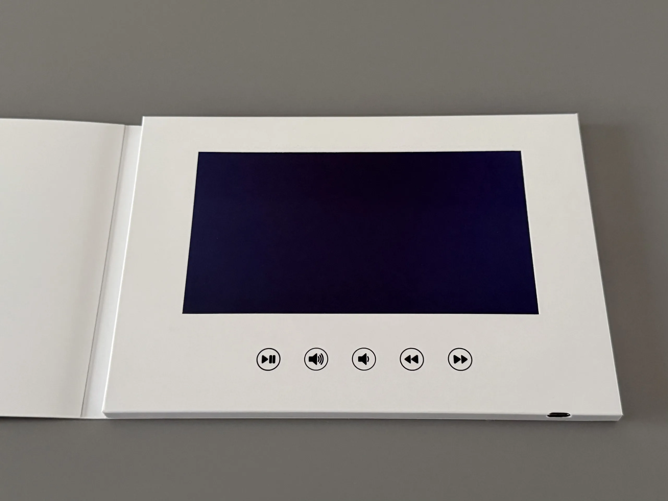 Video album z dużym ekranem 7 cali HD IPS oraz przyciskami sterującymi Play/Pauza, głośność +-, poprzedni, następny
